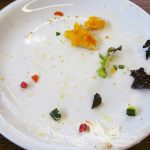 Empty plate with food scraps and crumbs left after a meal