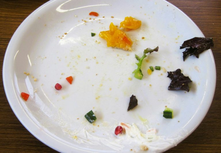 Empty plate with food scraps and crumbs left after a meal