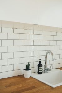 Photo of a kitchen sink with a tile splash